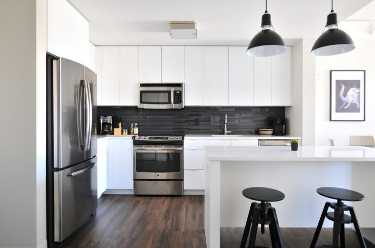 a kitchen with white cabinets and a black stool