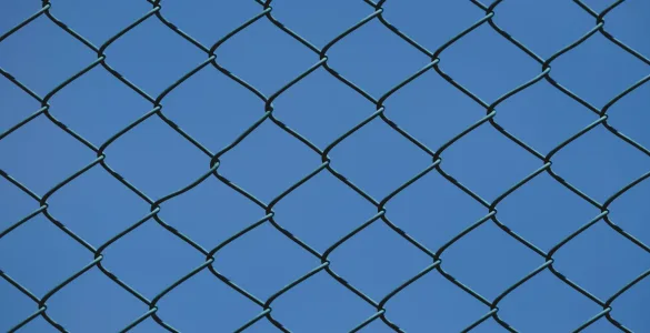 industrial chain link fence against blue sky