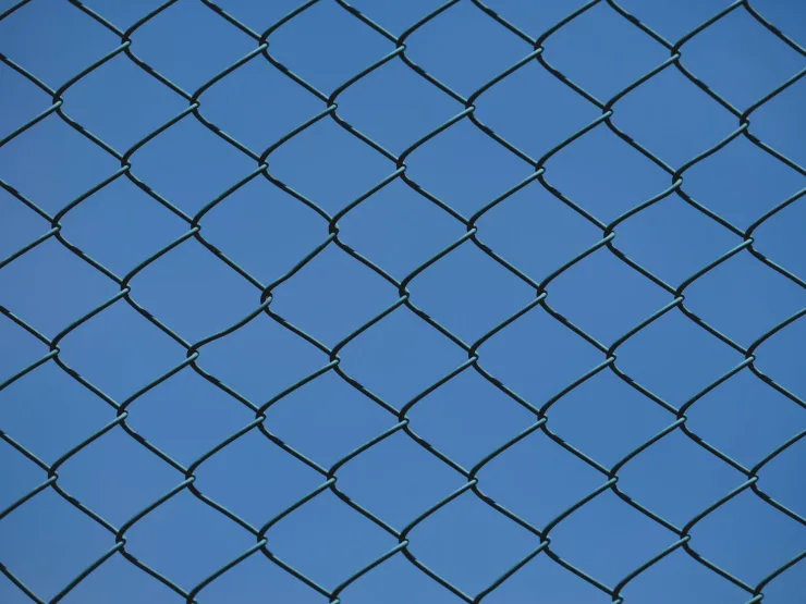industrial chain link fence against blue sky