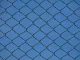 industrial chain link fence against blue sky